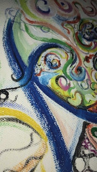 a close up of a colorful drawing on a piece of paper